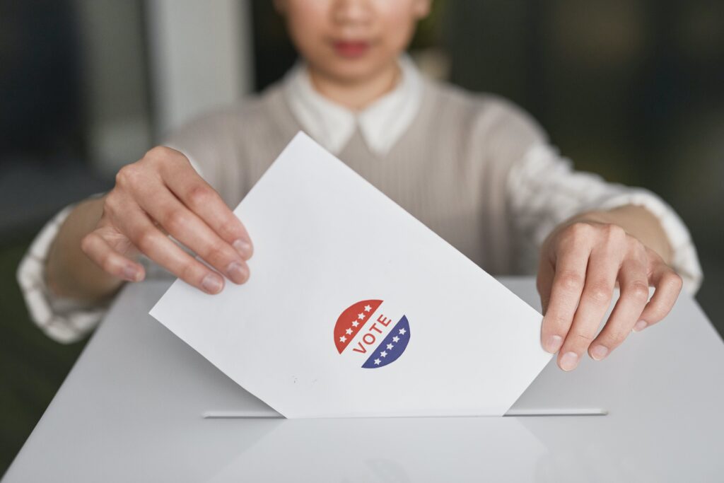 Voter with ballot at ballot box