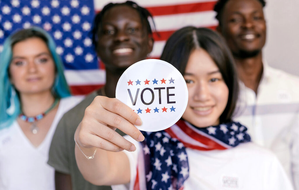 Young voters with VOTE sticker